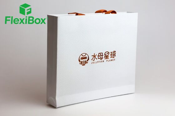 Branded White Specialty Paper Tote Bag with Orange Flat-Cord Handles and Custom Graphic